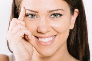 woman touching eyebrow