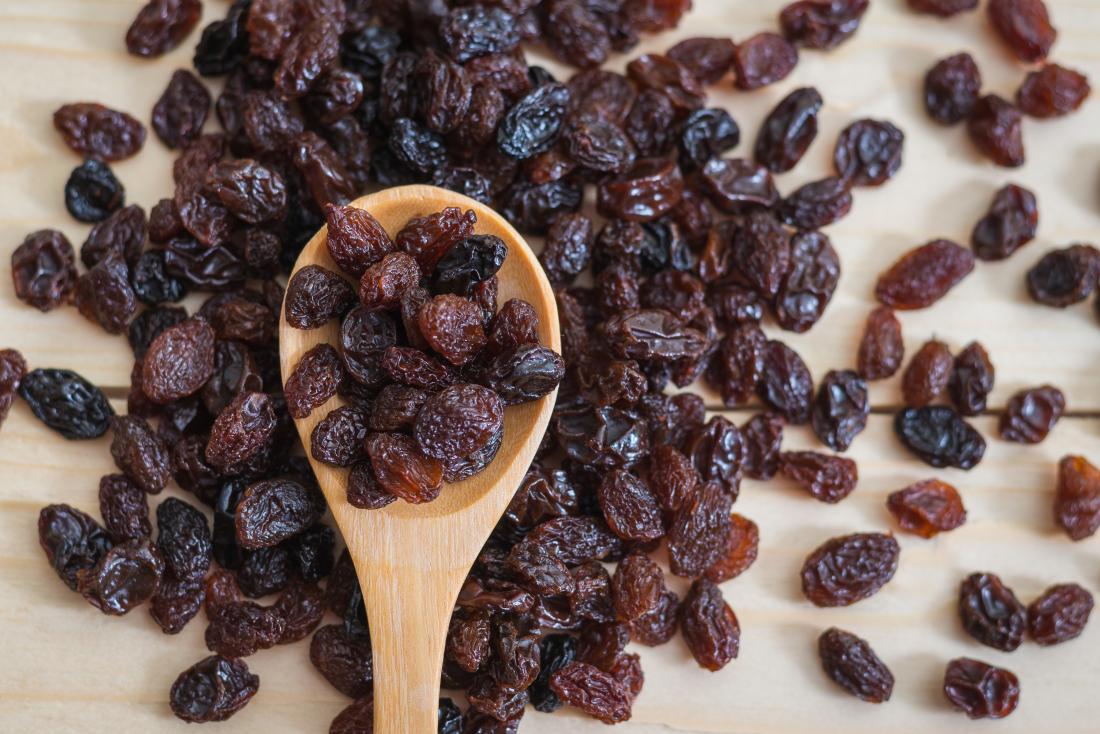 raisins on a wooden spoon