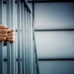 hands on jail bars 150x150 1