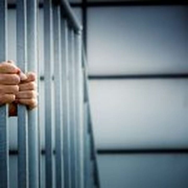 hands on jail bars 150x150 1